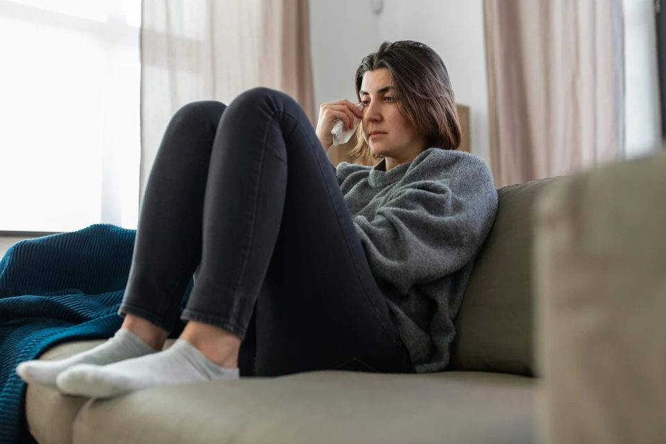 Upset young woman on a couch